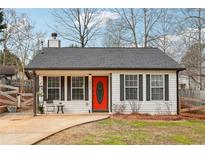 Charming home featuring a bright red front door and a well-maintained front yard at 2930 Lemans St, Cumming, GA 30041