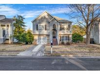 Charming two-story home with gray siding, stone accents, and a well-maintained front yard at 5806 Highgrove Dr, Atlanta, GA 30349