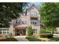 Charming brick townhome with well-maintained landscaping and inviting front entrance at 1365 Hawthorne Se Ave, Smyrna, GA 30080