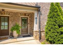 Charming brick home entrance with a well-manicured landscape and a cozy, inviting front door at 1365 Hawthorne Se Ave, Smyrna, GA 30080