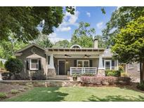 Charming one-story home with a covered front porch, manicured lawn, and lush landscaping at 167 Freyer Ne Dr, Marietta, GA 30060