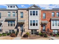 Charming townhouse with a brick facade and a well-manicured front yard at 2569 Village Park Bnd, Duluth, GA 30096