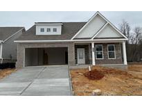 Charming single Gathering home featuring a brick facade, attached garage, and welcoming front porch at 2424 Anhinga Dr, Loganville, GA 30052