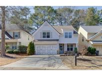 Charming two-story home featuring a well-manicured lawn and attached two-car garage at 270 Ascott Ln, Woodstock, GA 30189