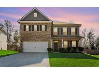 Beautiful two-story home featuring a brick and siding facade and manicured lawn at 238 Gallant Fox Way, Acworth, GA 30102