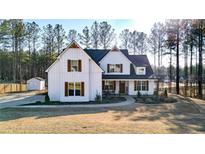 Beautiful two-story home with a covered front porch, wood accents, and a well-maintained lawn at 71 Presley Farm Ln, Rockmart, GA 30153