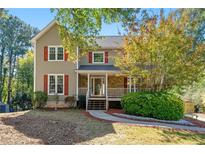 Charming two-story home featuring red shutters and a welcoming front porch at 1031 Steeple Run, Lawrenceville, GA 30043