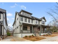 Charming two-story home featuring a covered porch, light siding, and dark trim at 965 Boulevard Se # B, Atlanta, GA 30312