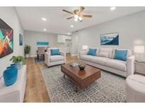 Open-concept living room features modern decor, wood floors, and neutral paint at 1179 Church St # J, Decatur, GA 30030