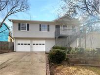 Charming two-story home with a two-car garage and an inviting front entrance with stairs at 3764 Cherokee Overlook Dr, Canton, GA 30115