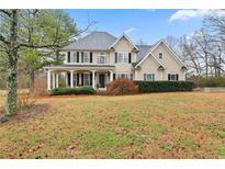 Charming two-story traditional home with a large front porch, manicured landscaping and a well kept lawn at 21 Cass Station Pass Nw Pass, Cartersville, GA 30121