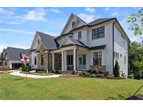 Beautiful new construction home featuring a stone and brick facade and well-manicured lawn at , Marietta, GA 30066