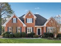 Charming two-story brick home with manicured lawn and lush landscaping at 5140 Sunset Maple Trl, Lilburn, GA 30047