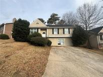 Charming two-story home featuring a well-manicured front yard, a symmetrical design and a private driveway at 5876 Old Wellborn Trce, Lithonia, GA 30058