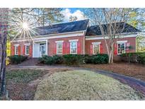 Charming brick home with red shutters, well-maintained landscaping, and inviting walkway to front door at 3587 Coldwater Canyon Ct, Tucker, GA 30084