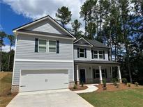 Two-story home featuring a two-car garage, gray siding, dark shutters, and manicured lawn at 19 Loth Wages (Lot 19) Rd, Dacula, GA 30019