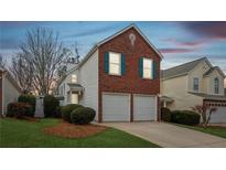 Charming brick and siding home with two-car garage and well-maintained landscaping at 2542 Albion Farm Way, Duluth, GA 30097