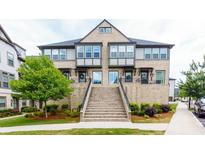 Inviting two-story townhome featuring brick facade, well-maintained landscaping, and a welcoming entrance staircase at 3785 Allegretto Cir # 230, Atlanta, GA 30339