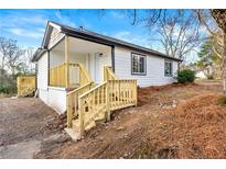 Charming renovated home with a new porch and stylish black and white color scheme at 2331 Luther St, Lithonia, GA 30058