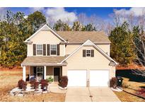 Charming two-story home featuring a manicured front yard and an attached two-car garage at 139 Concord Place, Hiram, GA 30141