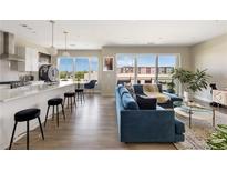 Bright, open-concept living space featuring hardwood floors, modern kitchen, and a comfortable seating area with balcony access at 22 Airline Ne St # 403, Atlanta, GA 30312