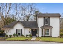 Charming two-story home with a well-manicured lawn, white brick facade, and black door at 2861 Dorby Close Ne, Brookhaven, GA 30319