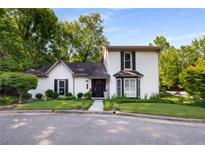 Charming two-story home with a landscaped yard, white brick, black shutters and a manicured lawn at 2861 Dorby Close Ne, Brookhaven, GA 30319