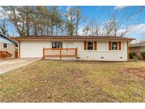 Charming single-story home with white brick, brown accents, and a cozy front porch at 2825 Middleburg Dr, Atlanta, GA 30349