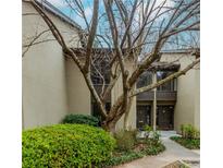 Inviting condo exterior featuring well-maintained landscaping, mature tree, and private entrances at 20 Ivy Ne Rdg, Atlanta, GA 30342