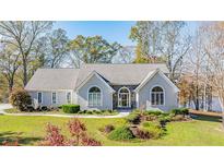 Beautiful single-story home featuring a stone facade, arched windows, and a well-maintained lawn at 205 Pine Knott Rd, Fayetteville, GA 30214