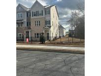 Charming townhome with a blend of brick and siding exterior and well-manicured landscaping at 1932 Appian Aly, Kennesaw, GA 30144