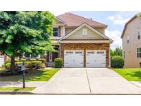 Charming two-story home with a well-manicured front yard and a two-car garage at 3455 Dalwood Dr, Suwanee, GA 30024