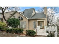 Charming townhouse featuring a landscaped front yard, inviting entryway, and classic architectural details at 1675 Paddlewheel Dr, Marietta, GA 30062