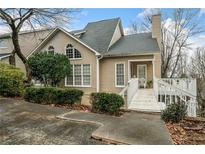 Charming home featuring a quaint entryway bridge, complemented by well-maintained landscaping, and an inviting atmosphere at 1675 Paddlewheel Dr, Marietta, GA 30062