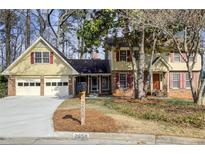 Charming two-story home features attached two-car garage, beautiful front yard with mature trees and well-maintained landscaping at 2658 Stonehenge Ct, Dunwoody, GA 30360