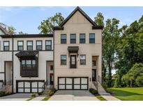 Charming townhome with a modern two-car garage and brick facade at 4524 Mikajack Se Dr, Smyrna, GA 30080