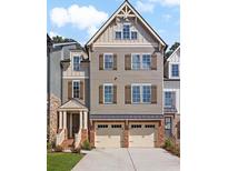 Charming three-story townhome with a brick foundation and a two-car garage at 300 Trecastle Ln # 26, Canton, GA 30114