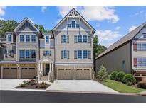 New construction townhome featuring neutral siding, three stories, and a spacious two-car garage at 222 Trecastle Sq # 21, Canton, GA 30114