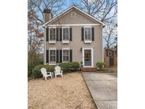 Charming home with a manicured front yard, window boxes, and a cozy seating area at 1925 Woodland Hills Nw Ave, Atlanta, GA 30318