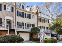 Charming townhomes featuring brick accents, black shutters, and well-maintained landscaping at 104 Terrace Dr # 6, Atlanta, GA 30305