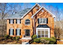 Charming brick home features a well-manicured lawn and a classic design, with black shutters and a gray roof at 3595 Mason Ridge Dr, Winston, GA 30187