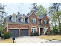 Lovely two story brick home with dormer windows and attached two car garage at 3553 Old Maple Dr, Johns Creek, GA 30022