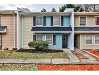 Charming townhome featuring a colorful facade, well-maintained landscaping, and welcoming entrance at 15 Pine Canyon Sw Dr, Atlanta, GA 30331