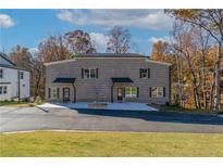 New construction gray brick duplex with black shutters and ample parking at 2381 Highpoint Rd, Snellville, GA 30078