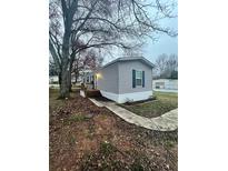 Charming single-story home with gray siding, neat landscaping, and a wooden porch at 463 Kingston Court, Hampton, GA 30228