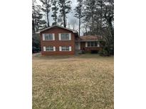 Charming two-story brick home with traditional architecture and a well-maintained front lawn at 1046 Sans Souci Way, Clarkston, GA 30021