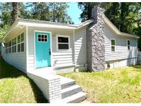 Charming single story home with stone chimney and a bright turquoise front door at 2346 Pryor Sw Rd, Atlanta, GA 30315