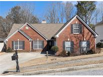 Charming one-story brick home with landscaped front yard and classic black shutters at 1176 Whatley Mill Ln, Lawrenceville, GA 30045