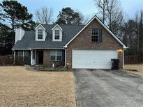 Charming brick home with a two-car garage and well-maintained landscaping at 310 Creekside Trl, Covington, GA 30016