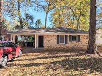 Charming brick home featuring a convenient carport, enhancing curb appeal and providing sheltered parking at 1692 Shirley Sw St, Atlanta, GA 30310